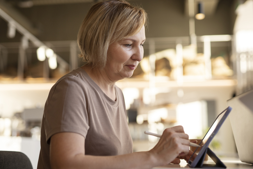 154117senior-woman-working-on-her-tablet-at-cafe.jpg